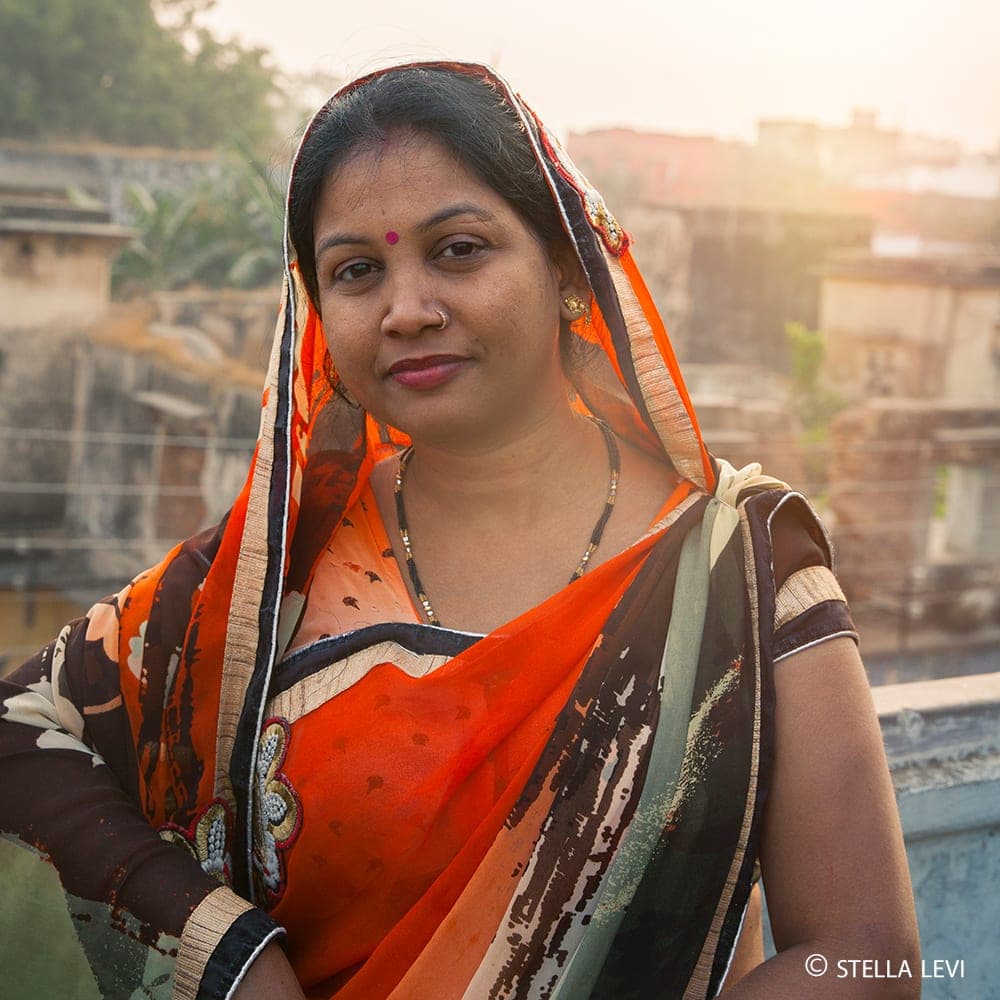 Photo of a woman in an orange sari in India